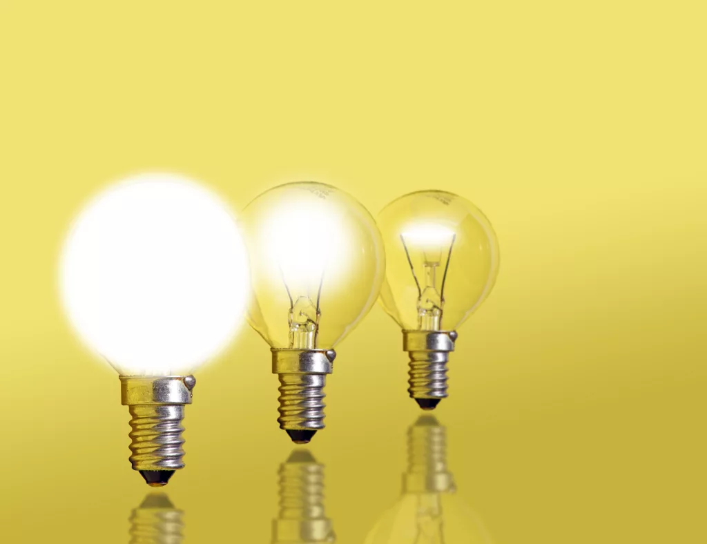 three lightbulbs in a row. the first is off, the second is dim, and the third is shining brightly